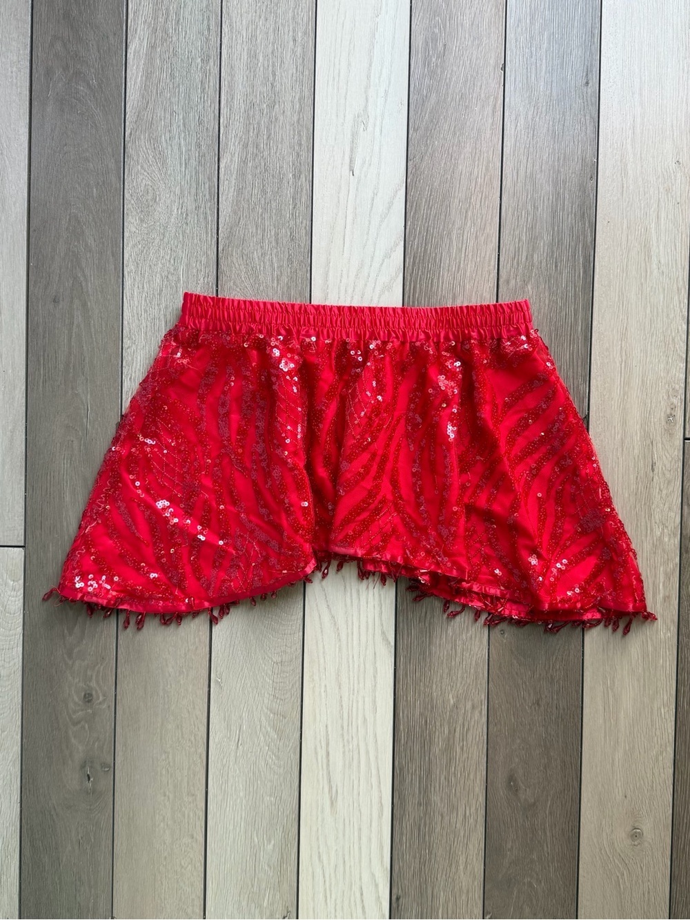 IHeartRaves red sequin skirt with fringe detailing.